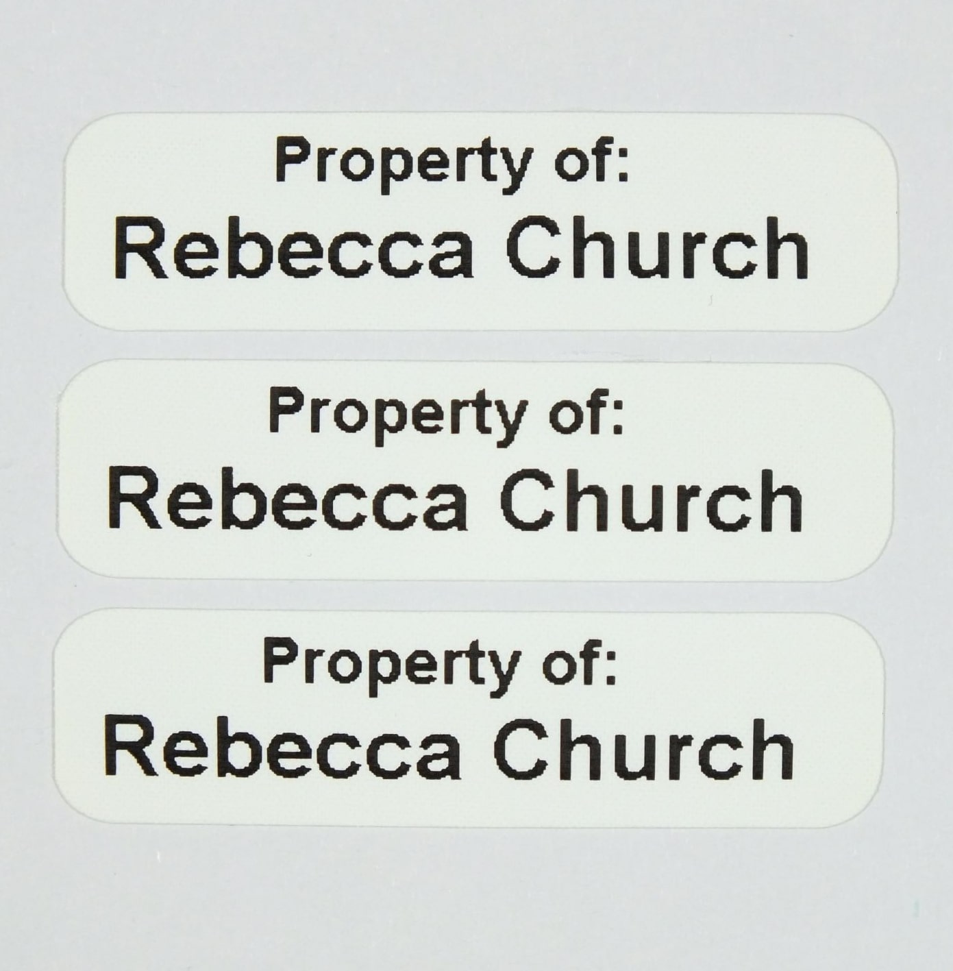 Die-Cut Iron-On Nametapes with rounded corners printed in Black. Ready to apply with a domestic iron.