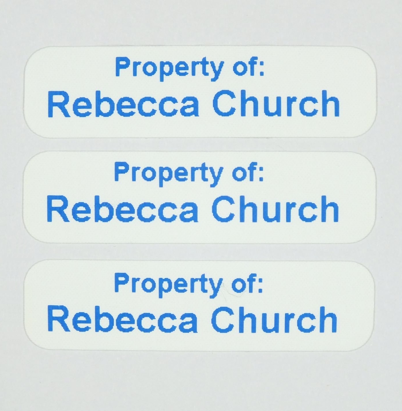 Die-Cut Iron-On Nametapes with rounded corners printed in Blue. Ready to apply with a domestic iron.