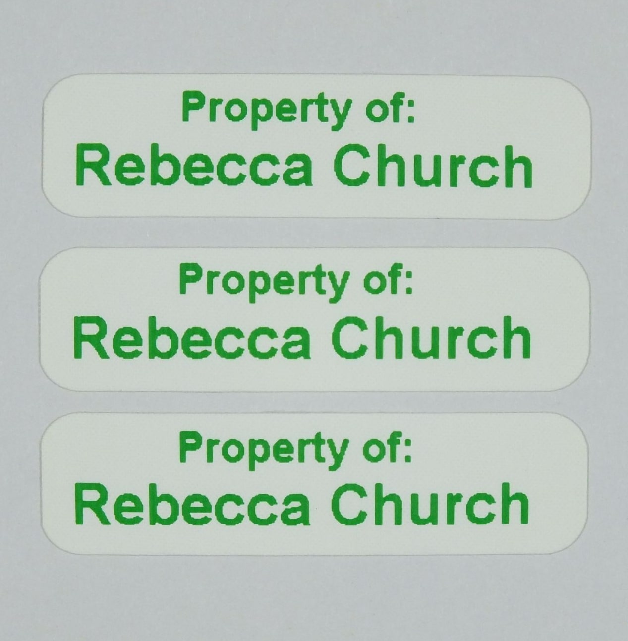 Die-Cut Iron-On Nametapes with rounded corners printed in Green. Ready to apply with a domestic iron.