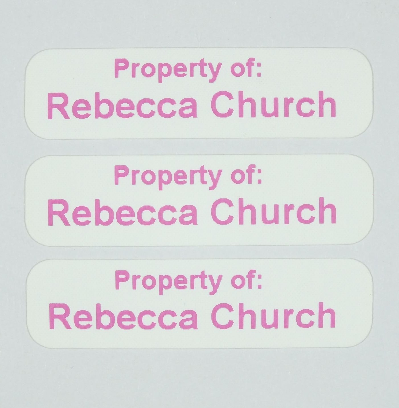 Die-Cut Iron-On Nametapes with rounded corners printed in Pink. Ready to apply with a domestic iron.
