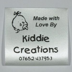 Custom printed fabric Baby design label. Black print on Silvery White material