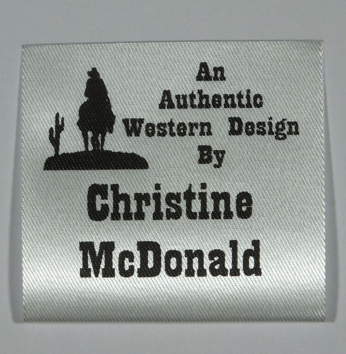 Soft Satin Western Design Sew-In Label. Black print on Silvery White material