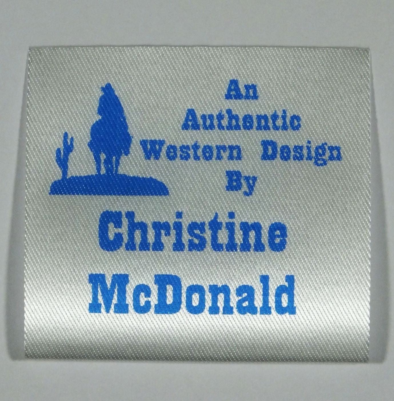 Soft Satin Western Design Sew-In Label. Blue print on Silvery White material