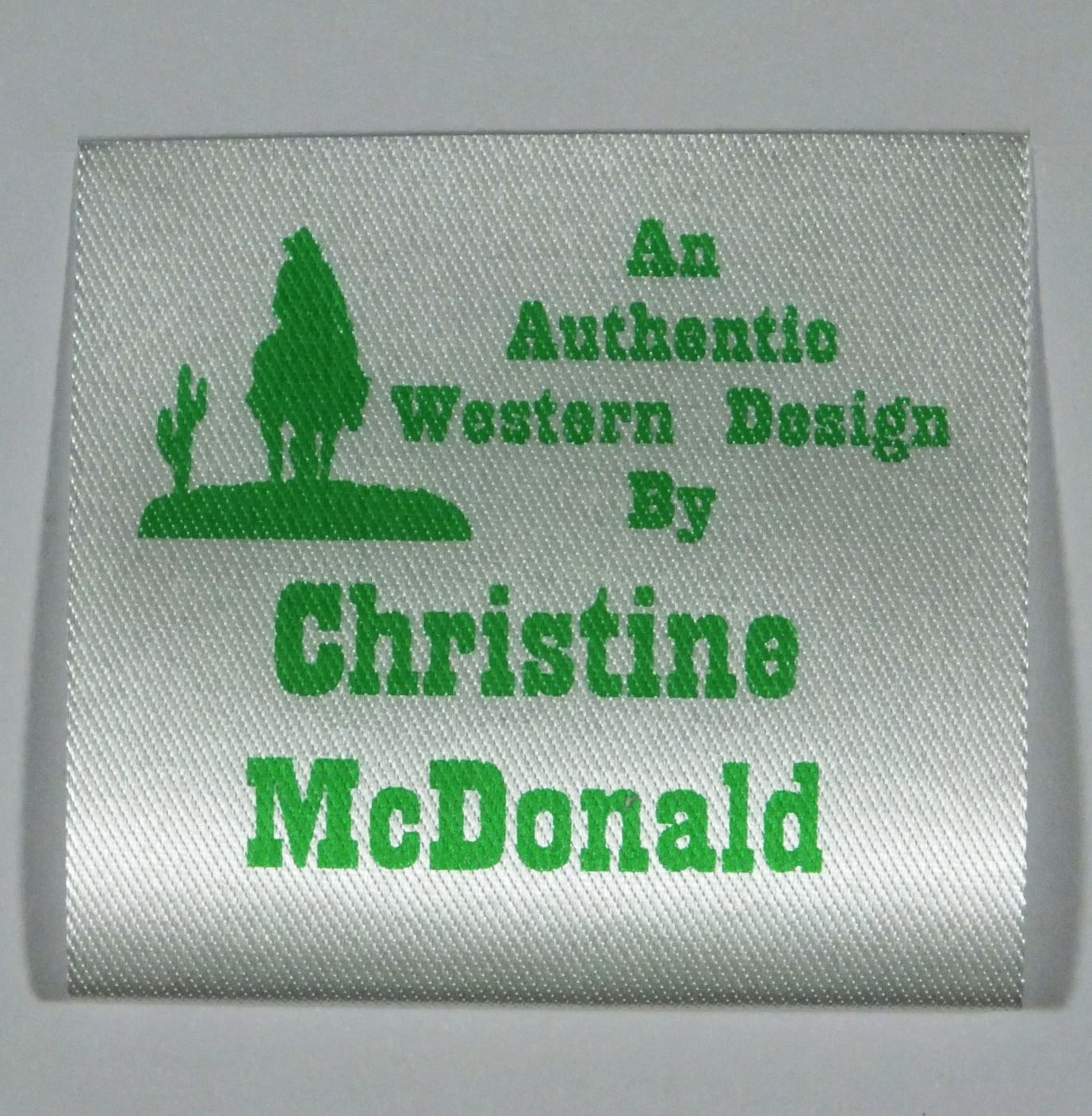 Soft Satin Western Design Sew-In Label. Green print on Silvery White material