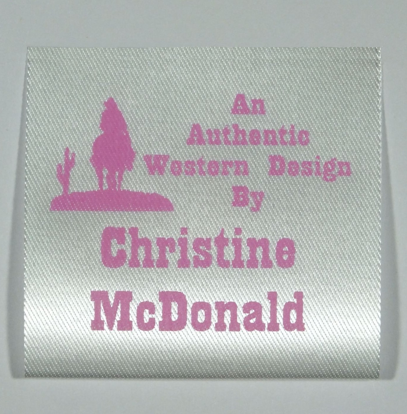 Soft Satin Western Design Sew-In Label. Pink print on Silvery White material