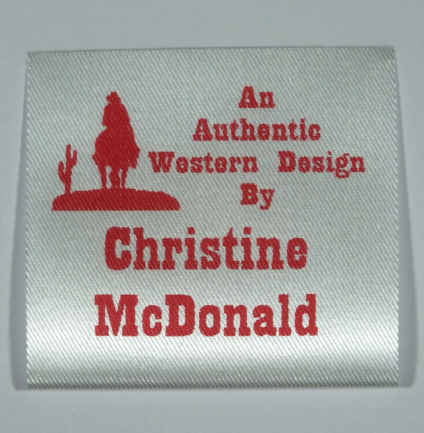 Soft Satin Western Design Sew-In Label. Red print on Silvery White material