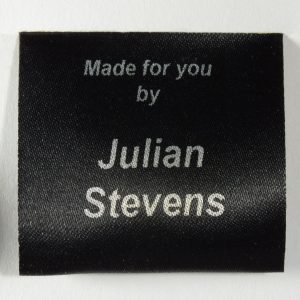 Black sew craft label with 5 lines of Silver print