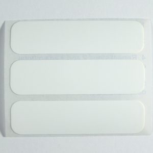 Blank ready cut iron on labels with rounded corners.